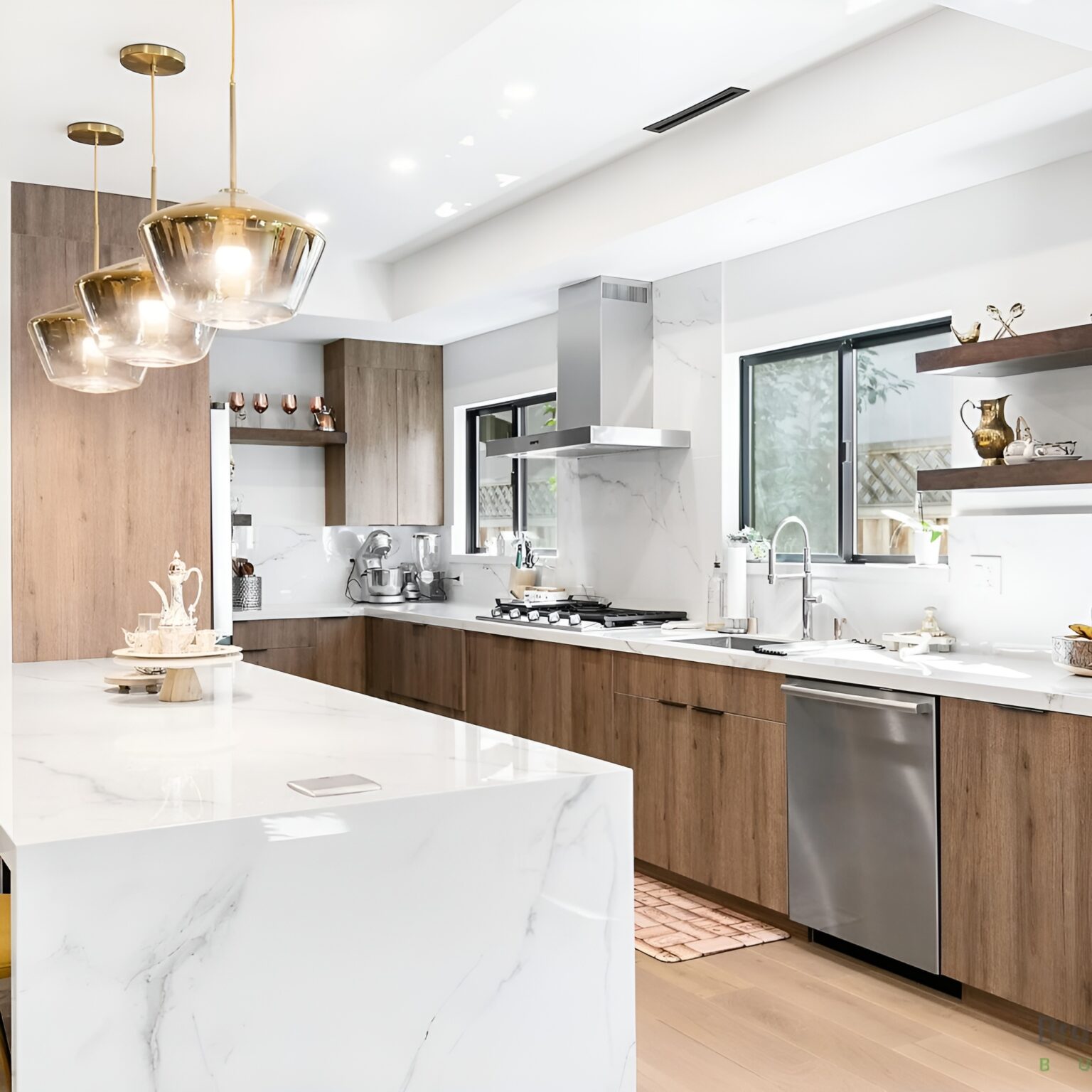 a kitchen with a marble island and stainless steel appliances