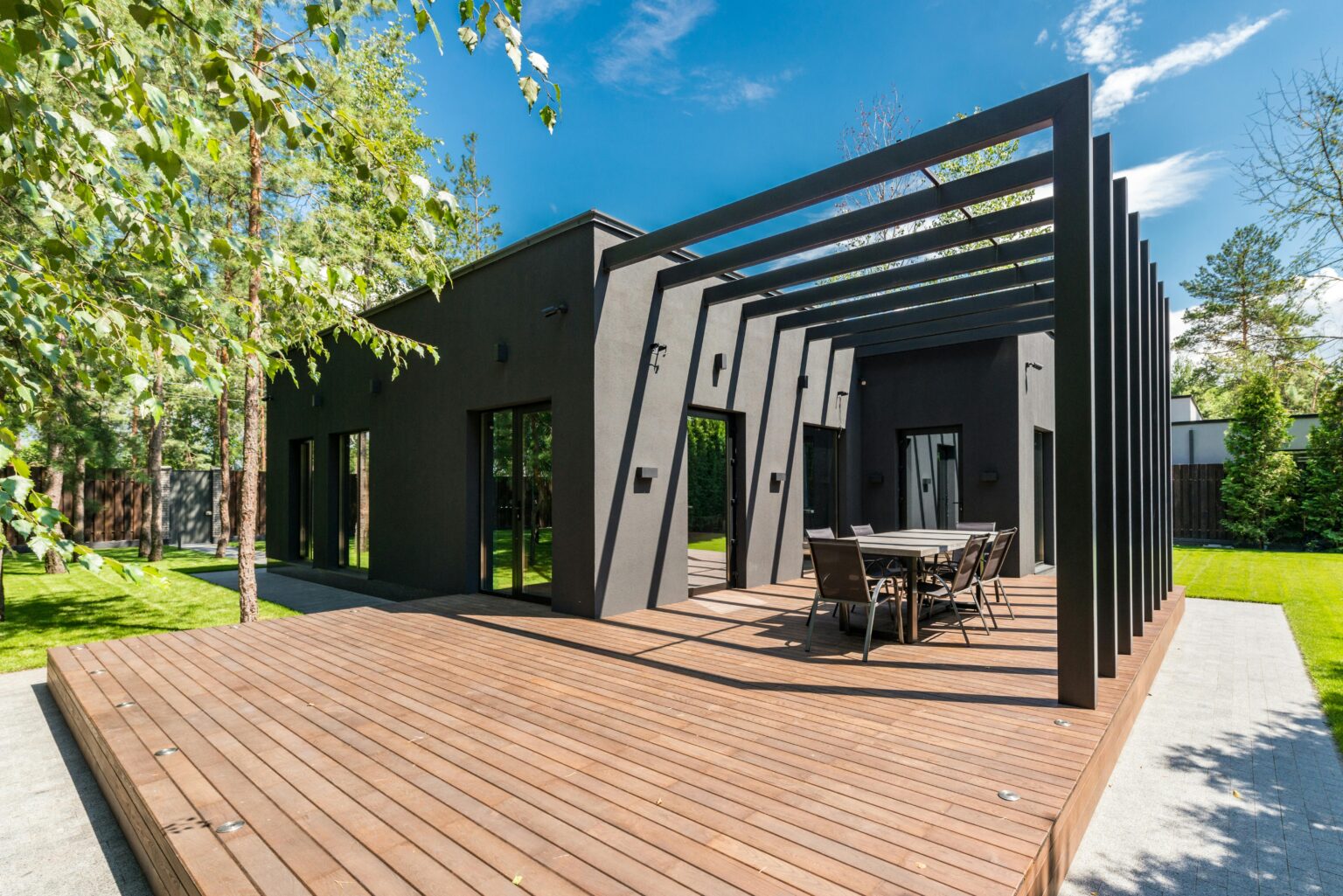 Deck Builder in Dublin 32 a house with a table and chairs on a deck. Geico Builders, the #1 ADU builder in Hayward