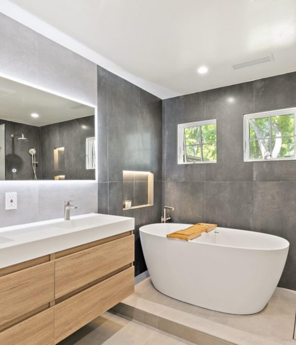 Home Remodel 82 bathroom remodel showcasing new floating wooden vanity and white porcelain free-standing tub