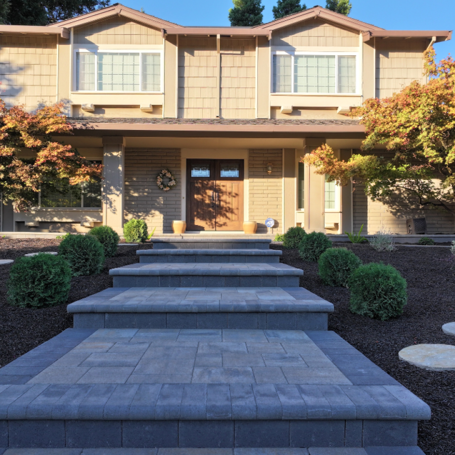 Copy of 13 Professional landscaping services. Paver staircase leading to the door of a large tan house in Alameda