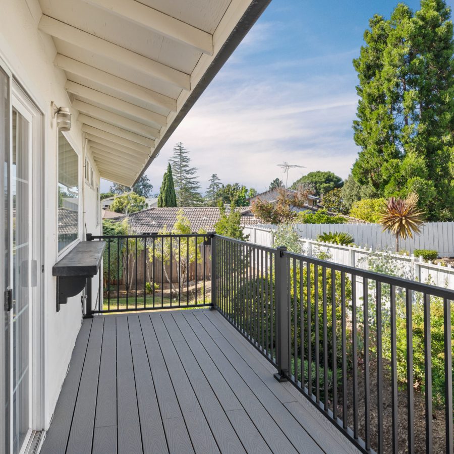 Copy of IMG_8215 Geico builders, the #1 trusted deck builder in Oakland. Deck with a railing and view of trees in the background