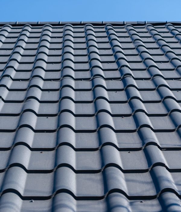 roof under construction with stacks of roof tiles for home building