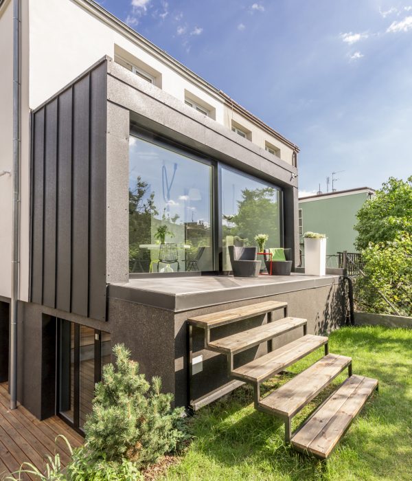 ADU Builder 39 Detached house with a veranda and wooden steps to the backyard