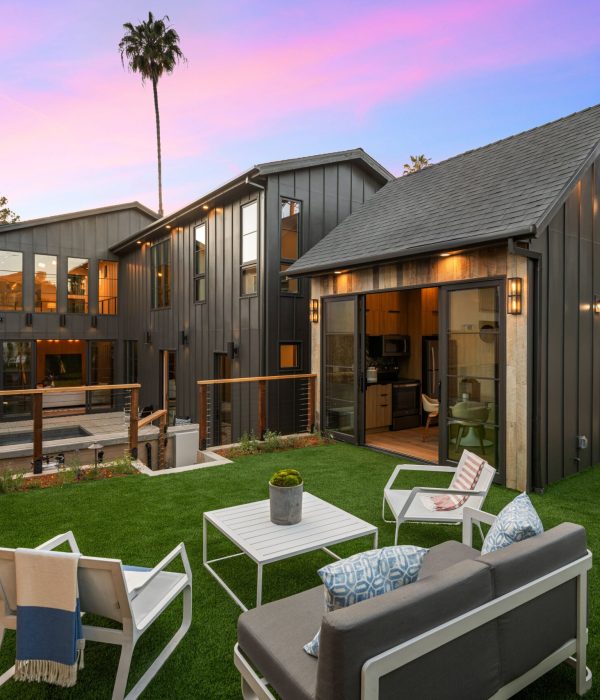 ADU Builder 48 A modern backyard with stylish patio furniture and a contemporary home at sunset. Southern California