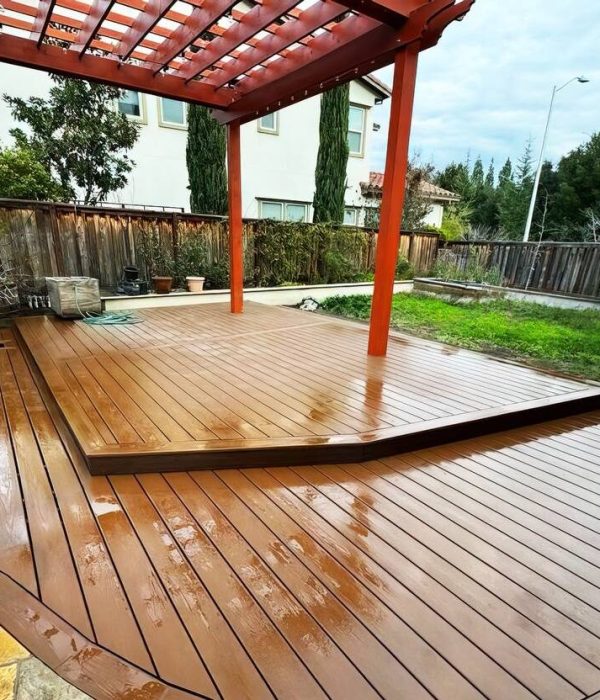 Deck Builder 55 Professionally installed wooden deck with a custom red wood pergola above it